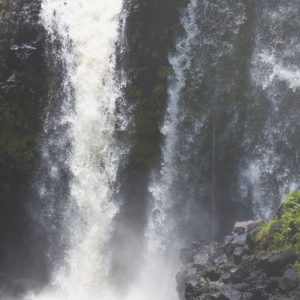 Young boy kayaking a waterfall