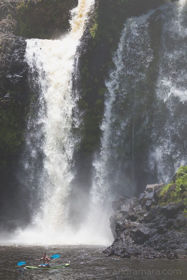 Young boy kayaking a waterfall
